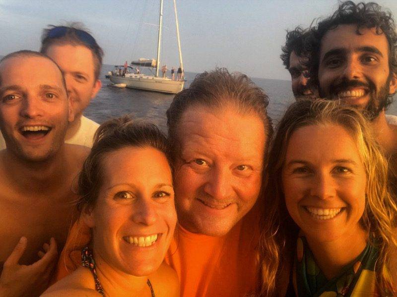 a group of people posing for a photo on a boat.