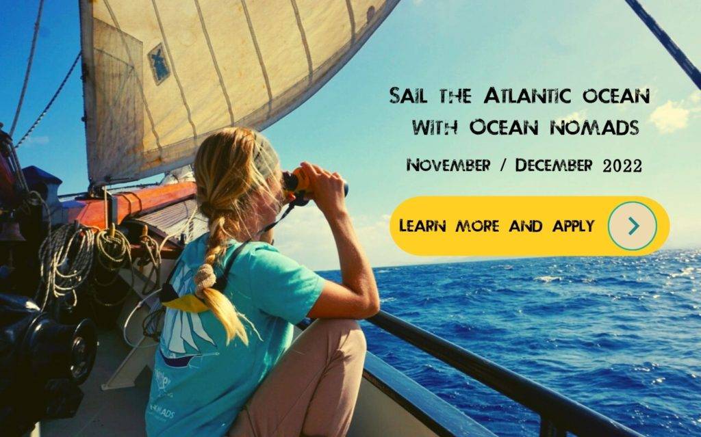 a woman on a boat looking at the ocean.