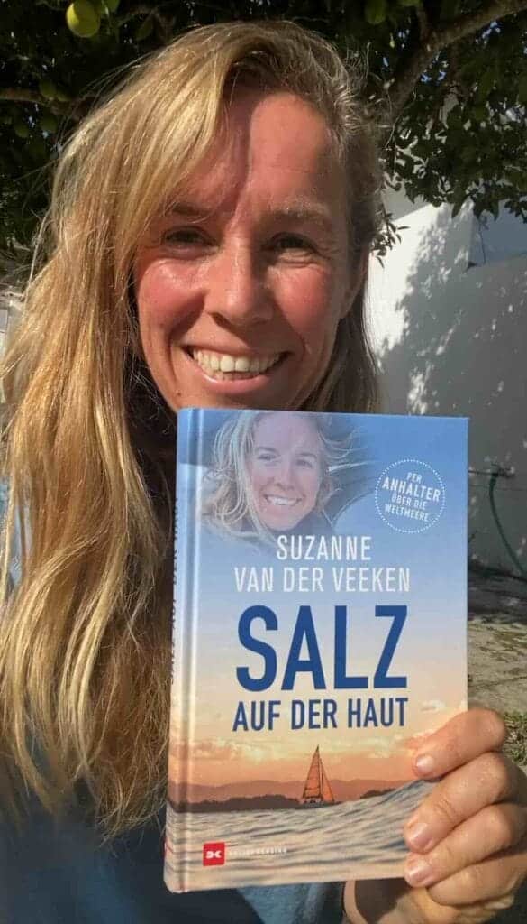 A person holds a book titled "Salz auf der Haut" by Suzanne van der Veeken, its cover depicting a serene blue sky and ocean. This copy is part of an exclusive Member Give-Away, making it a treasured find for lucky recipients.